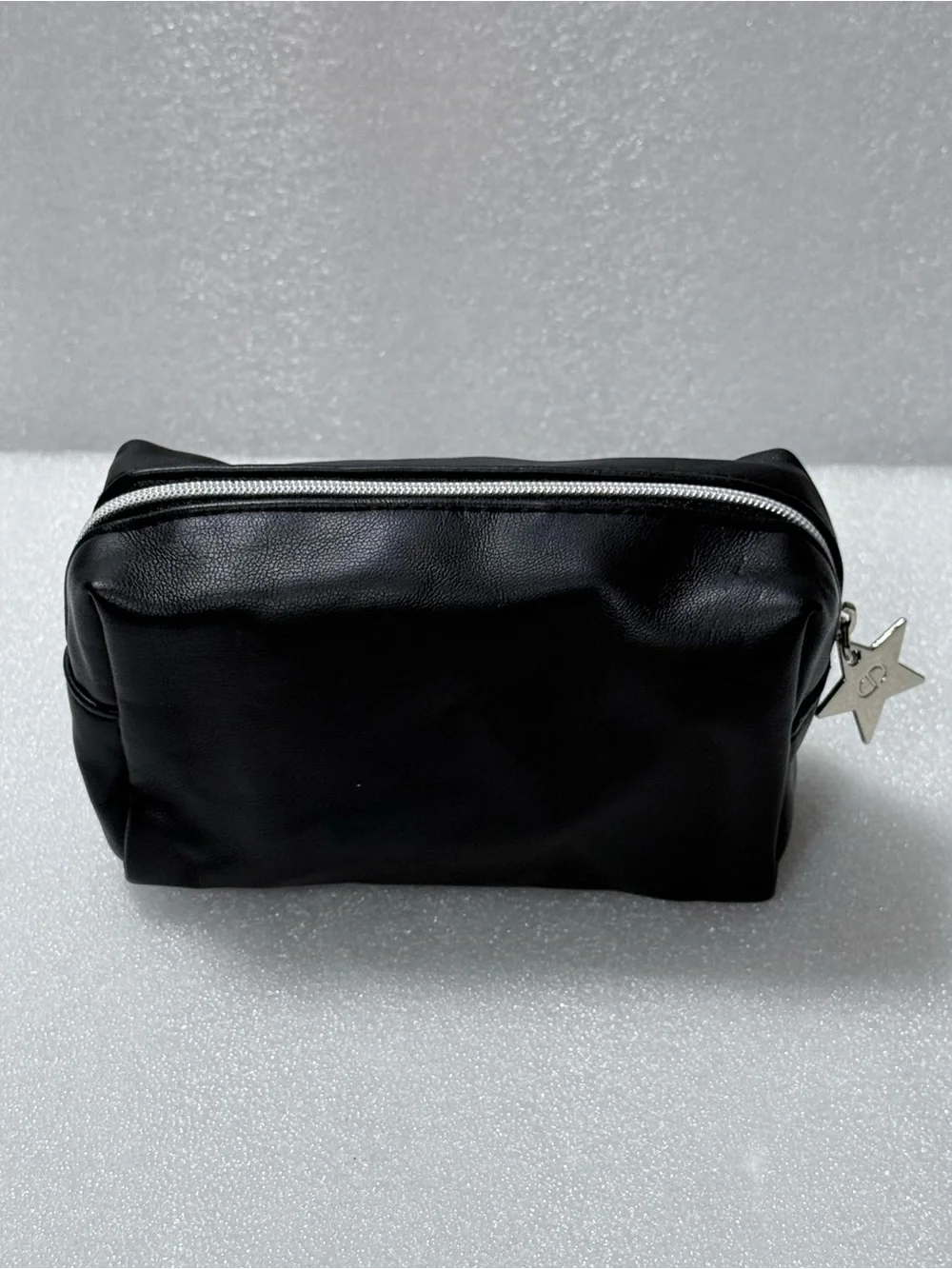 Dior makeup bag features a black exterior
